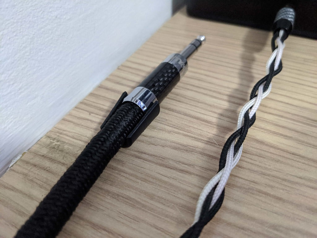Držák kabelu pro montáž pomocí oboustranné pásky nebo lepidla
