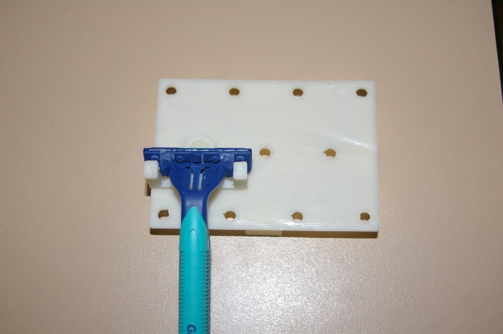 Jednorázový držák žiletky na zeď nebo mini stojánek