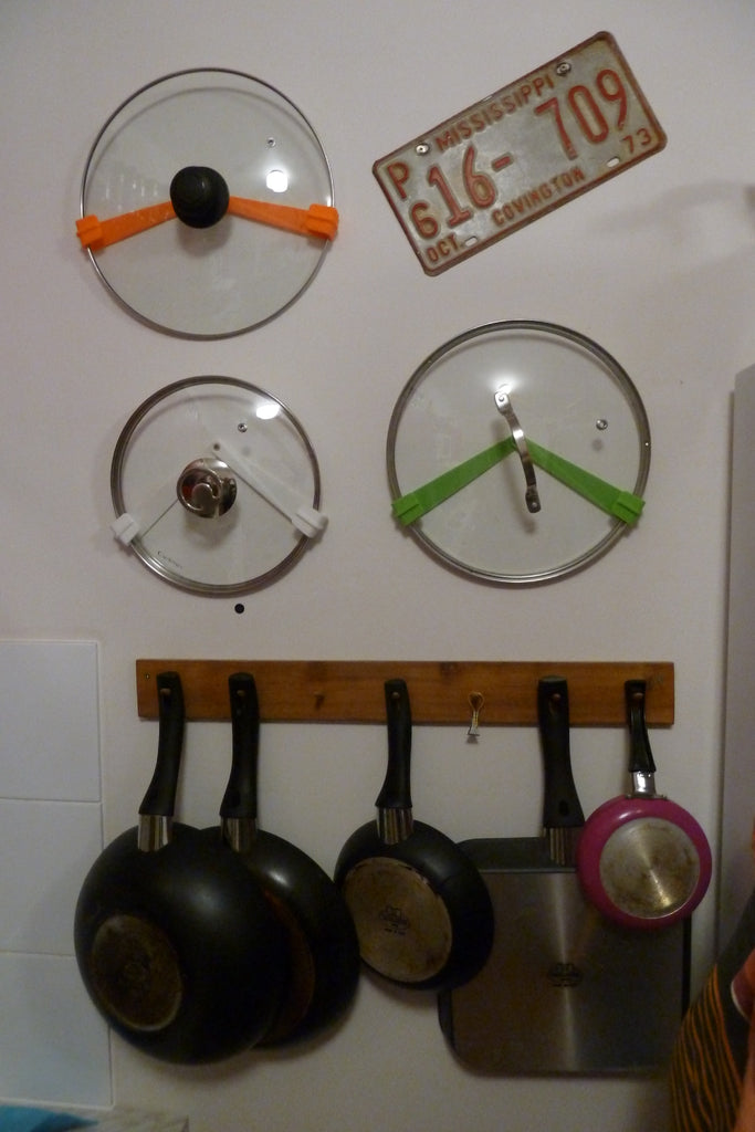 Nastavitelný držák poklice na kuchyňskou stěnu